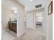 Hallway leading to a bathroom with double sinks and granite countertops at 5653 Sw 50Th Ter, Ocala, FL 34474