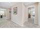 Hallway with neutral walls and carpet provides access to the home's other living spaces at 5653 Sw 50Th Ter, Ocala, FL 34474
