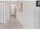 Neutral hallway with tile floors leading to a bright entryway at 5653 Sw 50Th Ter, Ocala, FL 34474