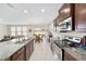 Well-lit kitchen showcases granite countertops, stainless steel appliances, and seamless flow into the living and dining areas at 5653 Sw 50Th Ter, Ocala, FL 34474
