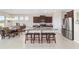 Modern kitchen with large island, granite counters, stainless steel appliances, and dark wood cabinetry at 5653 Sw 50Th Ter, Ocala, FL 34474