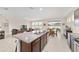 Bright, open kitchen featuring an island with granite countertops, tile flooring, and stainless steel appliances at 5653 Sw 50Th Ter, Ocala, FL 34474