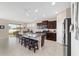 Spacious kitchen with large center island, granite countertops, and stainless appliances adjacent to the dining area at 5653 Sw 50Th Ter, Ocala, FL 34474