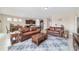 Spacious living room adjacent to dining area and open kitchen featuring tile flooring and modern finishes at 5653 Sw 50Th Ter, Ocala, FL 34474