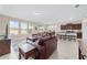Bright living room with tile floors, view to the back yard, with open access to dining and kitchen at 5653 Sw 50Th Ter, Ocala, FL 34474