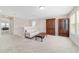 Bright loft area featuring a couch, coffee table, two windows for natural light and a cabinet at 5653 Sw 50Th Ter, Ocala, FL 34474