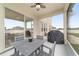 Covered porch featuring tile floor, a patio set, and backyard views at 5653 Sw 50Th Ter, Ocala, FL 34474