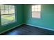 Bright bedroom with laminate flooring and natural light from dual windows at 616 Water Rd, Ocala, FL 34472
