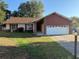 Charming single-story home with a two-car garage and well-maintained front lawn at 616 Water Rd, Ocala, FL 34472
