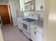Compact kitchen featuring a white electric range, a microwave, and ample cabinet space at 616 Water Rd, Ocala, FL 34472