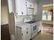 Efficient kitchen with white cabinets, an electric range, and views to the living area at 616 Water Rd, Ocala, FL 34472