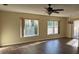 Inviting living room with wood floors, large windows, and a stylish ceiling fan at 616 Water Rd, Ocala, FL 34472