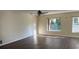 Bright living room featuring new flooring, a ceiling fan, and natural light from large windows at 616 Water Rd, Ocala, FL 34472