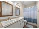 Bright bathroom featuring dual sinks, attractive mirrors, and a stylish shower at 6557 Se 4Th Ln, Ocala, FL 34472
