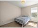 Inviting bedroom with large window, comfortable bed, and neutral decor at 6557 Se 4Th Ln, Ocala, FL 34472