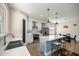 Bright kitchen features white cabinets, stainless steel appliances, a center island, and an adjacent dining area at 6557 Se 4Th Ln, Ocala, FL 34472