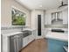 Bright kitchen with a stainless steel farmhouse sink, white cabinets and a breakfast bar at 6557 Se 4Th Ln, Ocala, FL 34472