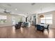 Open-concept living space features wood flooring, a dining area, and a view into the modern kitchen at 6557 Se 4Th Ln, Ocala, FL 34472