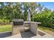Outdoor kitchen featuring a built-in grill and storage cabinets at 6557 Se 4Th Ln, Ocala, FL 34472