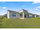Expansive backyard with covered patio, modern exterior, and lush lawn at 7199 Sw 60Th Ln, Ocala, FL 34474