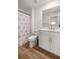 A bathroom featuring white cabinets and a flamingo shower curtain at 7199 Sw 60Th Ln, Ocala, FL 34474