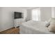 A bedroom featuring a TV, dresser, and white comforter at 7199 Sw 60Th Ln, Ocala, FL 34474