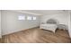 A lovely bedroom offers ample space, wood-look floors, and three bright windows at 7199 Sw 60Th Ln, Ocala, FL 34474