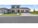 Charming two-story home featuring a manicured lawn, a two-car garage, and covered front porch at 7199 Sw 60Th Ln, Ocala, FL 34474