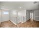 A brightly lit hallway with wood floors and white trim at 7199 Sw 60Th Ln, Ocala, FL 34474