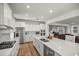 Bright kitchen with white cabinets and large island with seating, open to living area at 7199 Sw 60Th Ln, Ocala, FL 34474