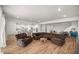 Open-concept living room with a kitchen island, dining table, and a large sectional at 7199 Sw 60Th Ln, Ocala, FL 34474