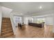 Open-concept living area with wood floors, a large sofa and lots of natural light at 7199 Sw 60Th Ln, Ocala, FL 34474