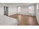Spacious main bedroom with wood-look flooring, two windows, and an ensuite bathroom entrance at 7199 Sw 60Th Ln, Ocala, FL 34474