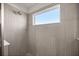 A tiled shower stall with a fixed shower head and clear window at 7199 Sw 60Th Ln, Ocala, FL 34474