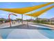 Splash pad with colorful water features under shade structures, chairs, and a swimming pool in the background at 7199 Sw 60Th Ln, Ocala, FL 34474