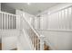 A wooden staircase with white wood railing and white trim at 7199 Sw 60Th Ln, Ocala, FL 34474