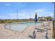 A relaxing swimming pool with sun umbrellas and lounge chairs with a well-manicured lawn and palm trees at 7199 Sw 60Th Ln, Ocala, FL 34474