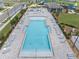 A beautiful swimming pool with lounge chairs and umbrellas, and a splash park next to the club house at 7199 Sw 60Th Ln, Ocala, FL 34474