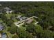 Aerial view of the home and neighborhood showcasing the property's location, lush landscaping, and mature trees at 8033 Nw 29Th Street Rd, Ocala, FL 34482