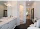 Modern bathroom features a sleek vanity, glass shower, and elegant lighting fixtures with access to the Primary bedroom at 8033 Nw 29Th Street Rd, Ocala, FL 34482