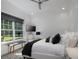 Bright bedroom with a large window, comfortable seating, ceiling fan, and flat screen television on the wall at 8033 Nw 29Th Street Rd, Ocala, FL 34482