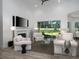 Elegant living room with fireplace, plush seating, and a serene view of the backyard at 8033 Nw 29Th Street Rd, Ocala, FL 34482