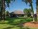 Exterior view of home highlighting the screened porch, landscaping, and beautiful backyard at 8033 Nw 29Th Street Rd, Ocala, FL 34482