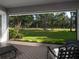Spacious screened porch with tile flooring featuring a panoramic view of the lush green backyard at 8033 Nw 29Th Street Rd, Ocala, FL 34482