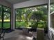 Screened-in porch overlooking the golf course, with a fountain and access to the beautifully landscaped backyard at 8033 Nw 29Th Street Rd, Ocala, FL 34482