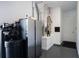 Utility area featuring a water filtration system, refrigerator, and access to the home's mechanical systems at 8033 Nw 29Th Street Rd, Ocala, FL 34482