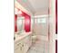 Bathroom with red accent wall and standard tub and shower at 8375 Sw 109Th Lane Rd, Ocala, FL 34481