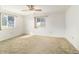 Bright bedroom with neutral carpet, ceiling fan and large windows at 8375 Sw 109Th Lane Rd, Ocala, FL 34481