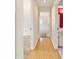 Hallway view with hardwood floors and open doorway into bedroom at 8375 Sw 109Th Lane Rd, Ocala, FL 34481
