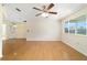 Bright living room with hardwood floors, ceiling fan, large window, and dining area at 8375 Sw 109Th Lane Rd, Ocala, FL 34481